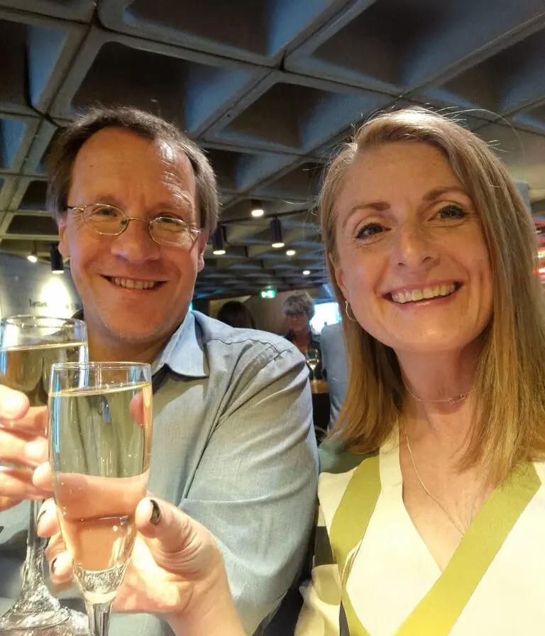 Catrin and Aran from SaySomethingin toast a glass of champagne in celebration.
