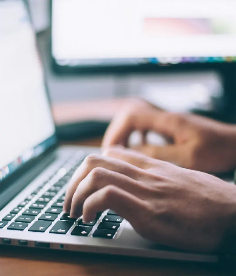 Typing at a laptop keyboard